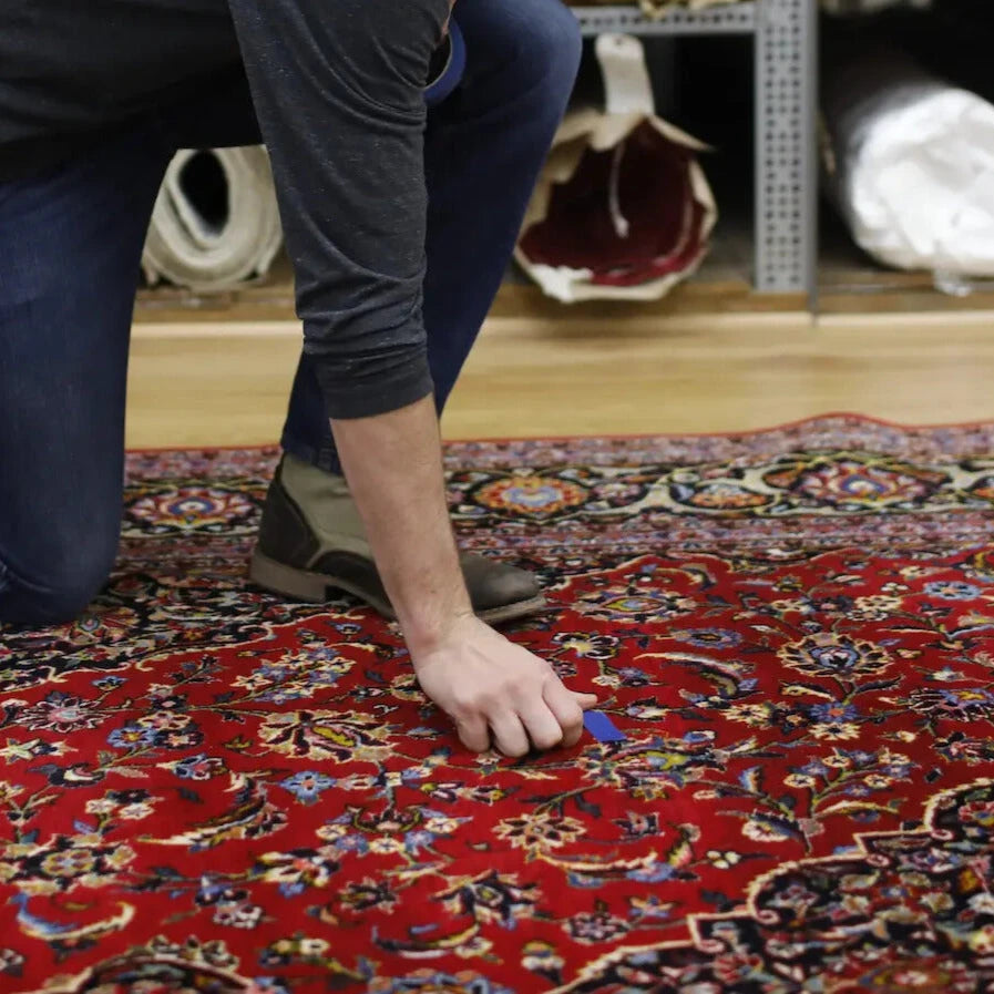 Appraiser assessing rug